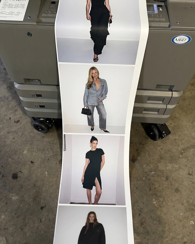 A long strip of printed looks rolling out of an office printer onto a concrete floor: women in black, in double denim, in a black dress.