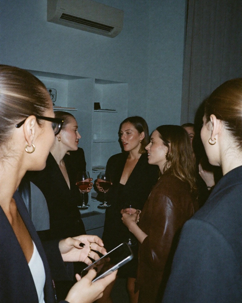 Women in dark blazers talking over glasses of wine at an NMBRD evening.